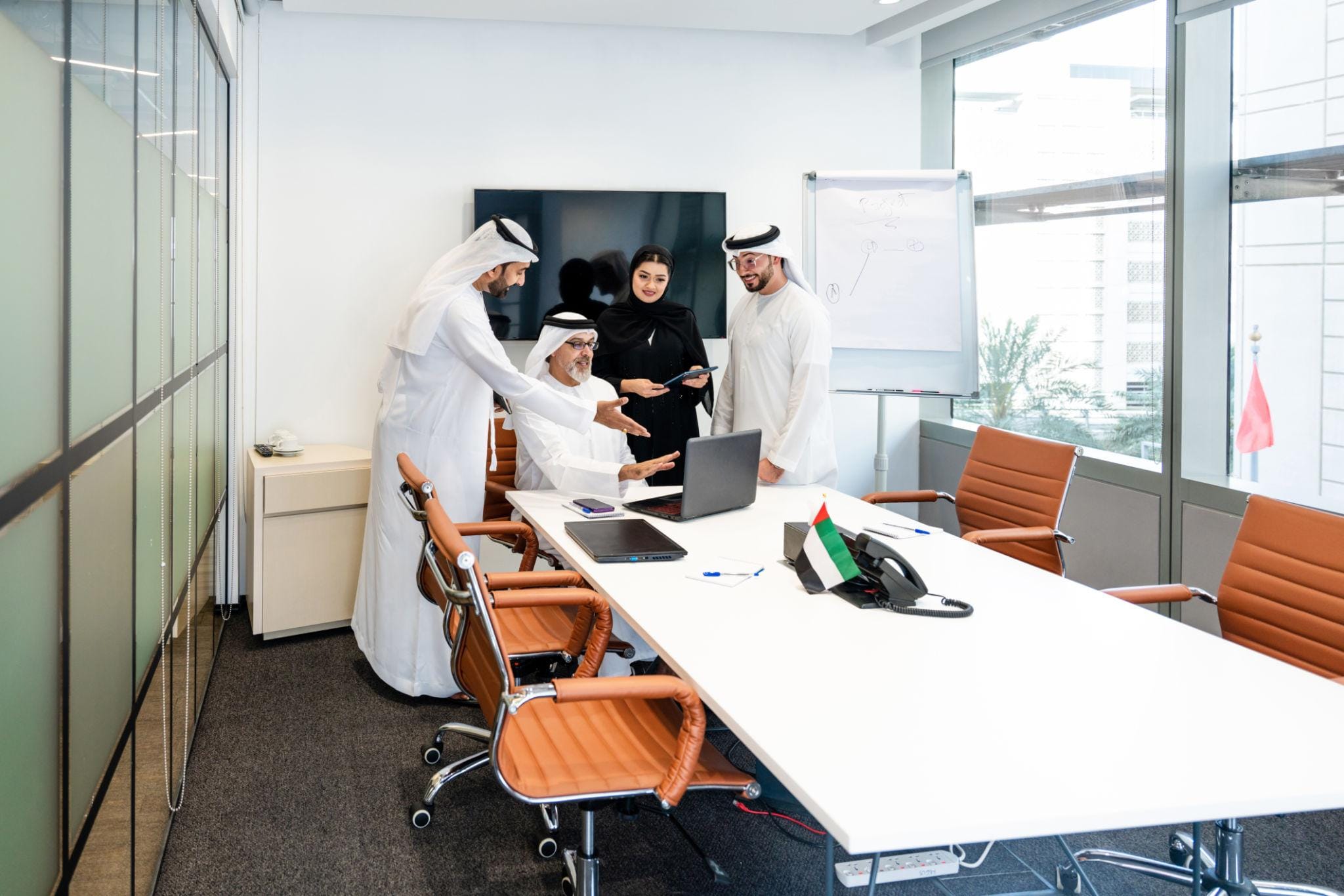 Professional team discussing Qatar branch office setup and corporate strategy