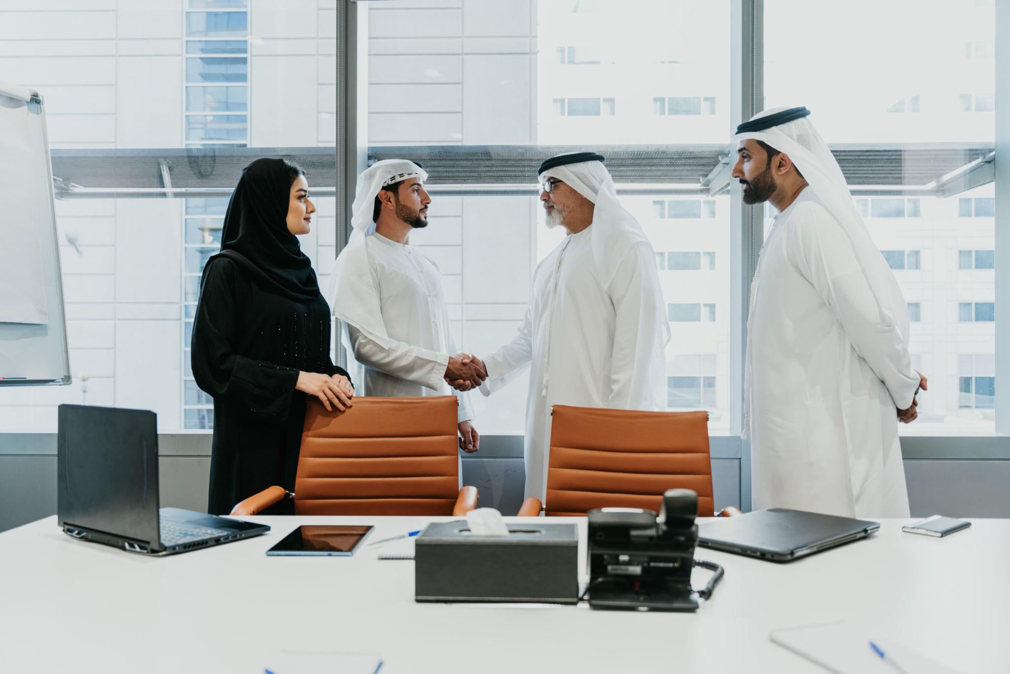 Professional team discussing Qatar branch office setup and corporate strategy